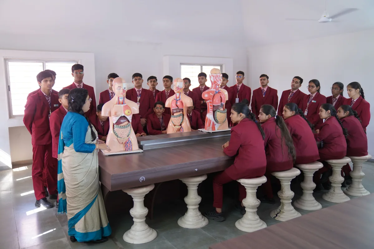 Students in India learning biology with anatomical models